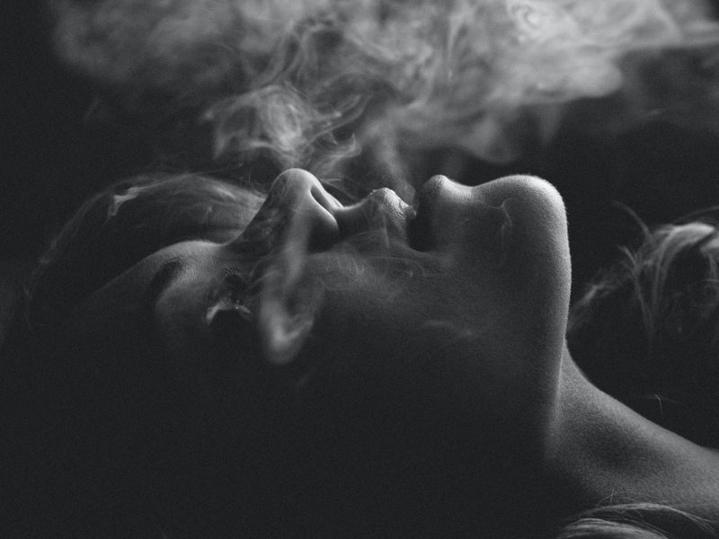 Portrait of young woman and smoke